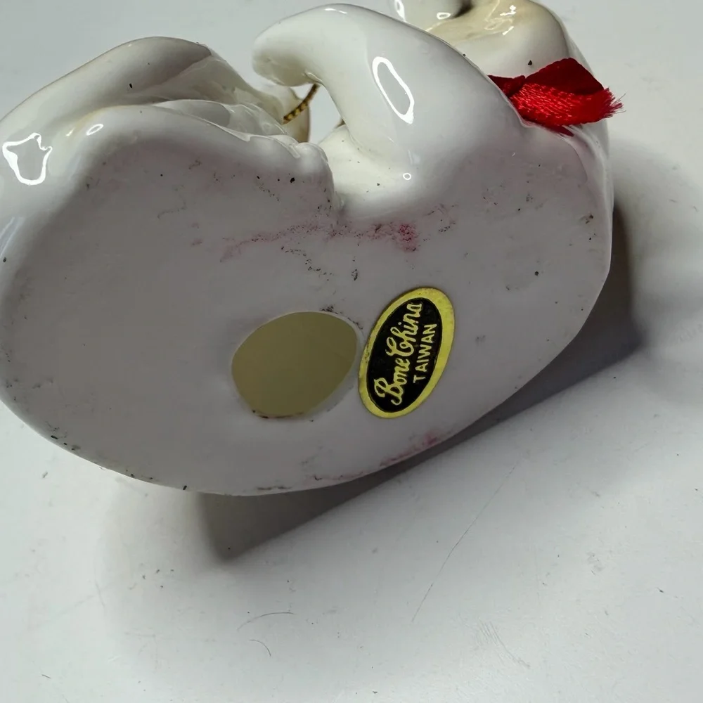 Decorative White and Tan Ceramic Cat Ornament with Red Bow